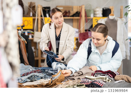 Family Shopping. Positive mother and daughter choosing pants or stylish trousers in clothing mall. Black Friday sale of winter clothing collection 131969984