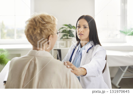 Doctor Or Nurse Assisting Senior Patient During Hospital Appointment Doctor Or Nurse Assisting Senior Patient During Hospital Appointment 131970645