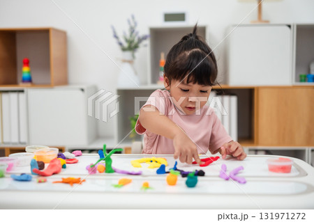 toddler girl with sculpting from plasticine toddler girl with sculpting from plasticine 131971272