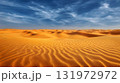 A wide shot of desert dunes with a blue sky and white clouds. A wide shot of a large sand dune in a desert landscape with a blue sky and white clouds. Vast expanse of golden sand dunes under a vibrant 131972972