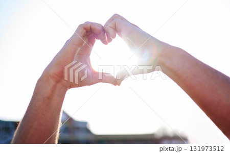 Love, heart and hands with sunshine, support and collaboration with light, mockup and outdoor. Closeup, zoom and sign with lens flare, community and peace with wellness, care and kindness outside 131973512