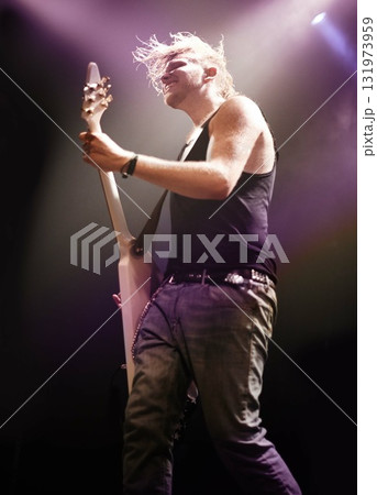 Music, festival and man with guitar on a stage for performance, passion or artistic freedom. Rock, concert and guy musician on electric musical instrument, night or rockstar event in metal aesthetic Music, festival and man with guitar on a stage for performance, passion or artistic freedom. Rock, concert and guy musician on electric musical instrument, night or rockstar event in metal aesthetic 131973959