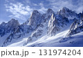 Snow covered mountain peaks under a clear sky. 131974204