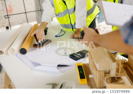 Architect Asian team working with colleagues in the construction site. Architecture engineering on big project. Architect Asian team working with colleagues in the construction site. Architecture engineering on big project. 131974999