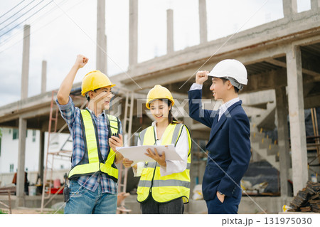 Engineer desk with object paper and tablet with blurry engineer teamwork hardworking to consults about their building Engineer desk with object paper and tablet with blurry engineer teamwork hardworking to consults about their building 131975030