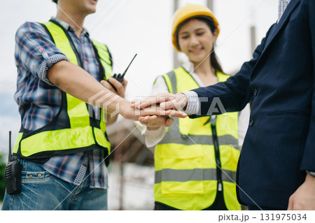 Asian Engineer and contractor join hands after signing contract,They are having a modern building project together. Asian Engineer and contractor join hands after signing contract,They are having a modern building project together. 131975034