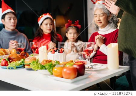 Celebrate Christmas with family in a cozy, festive setting. Santa hats, gifts, and delicious food capture the warmth, joy Celebrate Christmas with family in a cozy, festive setting. Santa hats, gifts, and delicious food capture the warmth, joy 131975275