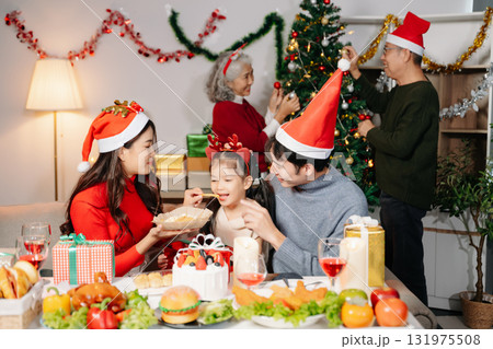 Celebrate Christmas with family in a cozy, festive setting filled with gifts, love, and joy. Celebrate Christmas with family in a cozy, festive setting filled with gifts, love, and joy. 131975508