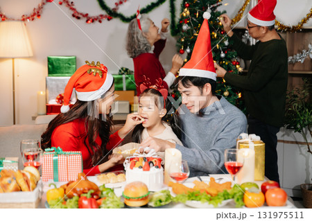 Celebrate Christmas with family in a cozy, festive setting filled with gifts, love, and joy. 131975511