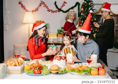 Celebrate Christmas with family in a cozy, festive setting filled with gifts, love, and joy. Celebrate Christmas with family in a cozy, festive setting filled with gifts, love, and joy. 131975512
