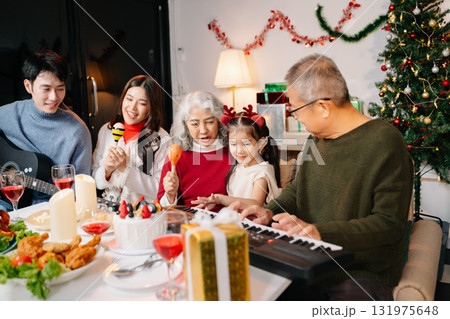 Celebrate Christmas with family in a cozy, festive setting filled with gifts, love, and joy. 131975648