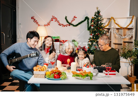 Celebrate Christmas with family in a cozy, festive setting filled with gifts, love, and joy. 131975649