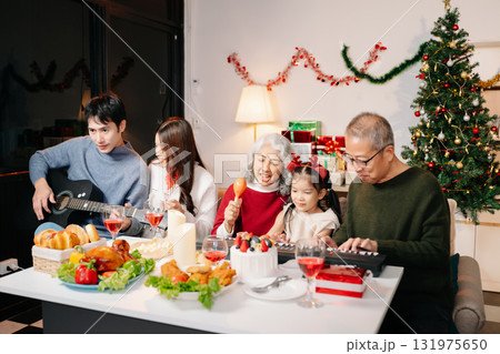 Celebrate Christmas with family in a cozy, festive setting filled with gifts, love, and joy. 131975650