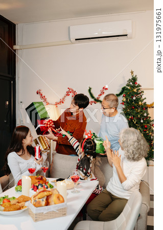 Celebrate Christmas with family in a cozy, festive setting filled with gifts, love, and joy. Capture the spirit of holiday 131975661