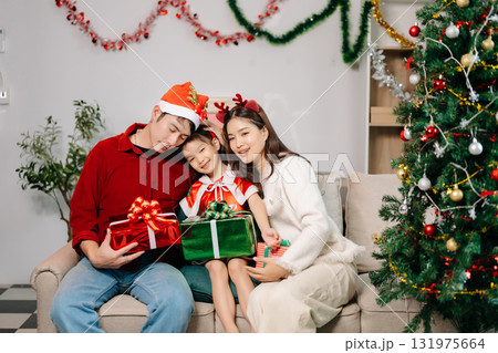 Celebrate Christmas with family in a cozy, festive setting filled with gifts, love, and joy. Celebrate Christmas with family in a cozy, festive setting filled with gifts, love, and joy. 131975664