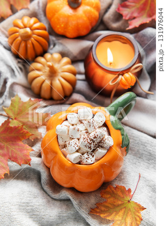 Pumpkin mug of hot chocolate with marshmallows cozy autumn scene 131976044