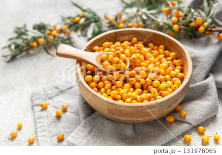 Sea buckthorn berries in wooden bowl Sea buckthorn berries in wooden bowl 131976065