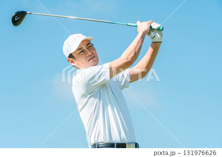 ゴルフ場でドライバーを振るゴルファーの男性(青空) ゴルフ場でドライバーを振るゴルファーの男性(青空) 131976626