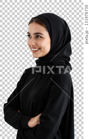 Woman Hijab Smiling. A young woman wearing a black hijab and abaya smiles warmly while looking off to her right 131976730