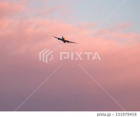 夕暮れの赤く染まった空とこれから着陸する飛行機 131979459