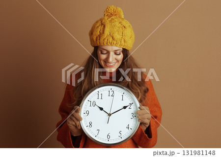 Cheerful Woman Adjusting Time in Fall Fashion 131981148