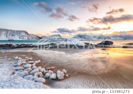 Amazing winter view of Vik beach during sunset with lots of snow and snowy mountain peaks near Leknes. Amazing winter view of Vik beach during sunset with lots of snow and snowy mountain peaks near Leknes. 131981273