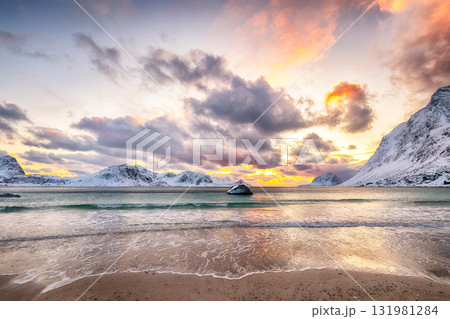 Amazing winter scenery with Haukland beach during sunset and snowy mountain peaks near Leknes. Amazing winter scenery with Haukland beach during sunset and snowy mountain peaks near Leknes. 131981284