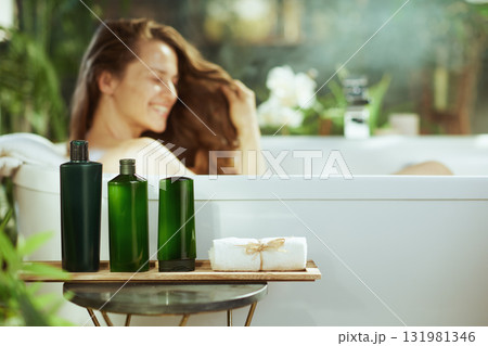 Woman Enjoying Bath with Natural Products in Spa Setting Woman Enjoying Bath with Natural Products in Spa Setting 131981346