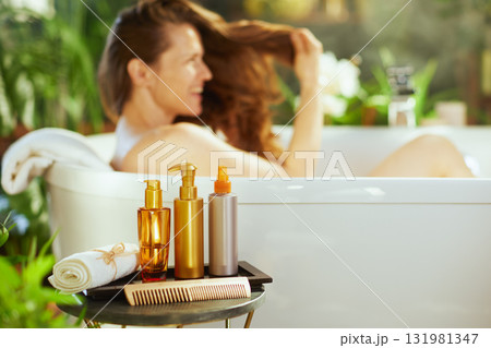 Woman Smiling in Bath with Hair and Body Care Woman Smiling in Bath with Hair and Body Care 131981347