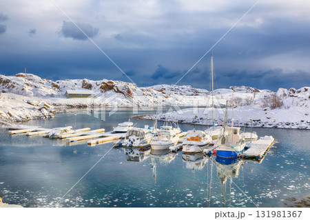 Unbelivable winter scenery with yachts and boats nier pier in small fishing village and snowy mountain peaks near Valberg Unbelivable winter scenery with yachts and boats nier pier in small fishing village and snowy mountain peaks near Valberg 131981367