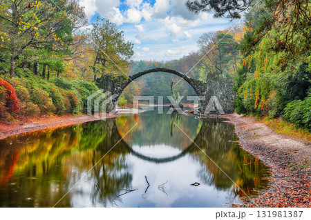 Amazing autumn landscape in Kromlau Rhododendron Park . Rakotz Bridge (Rakotzbrucke, Devil's Bridge) Amazing autumn landscape in Kromlau Rhododendron Park . Rakotz Bridge (Rakotzbrucke, Devil's Bridge) 131981387