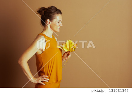Peaceful Woman Admiring Autumn Leaves 131981545