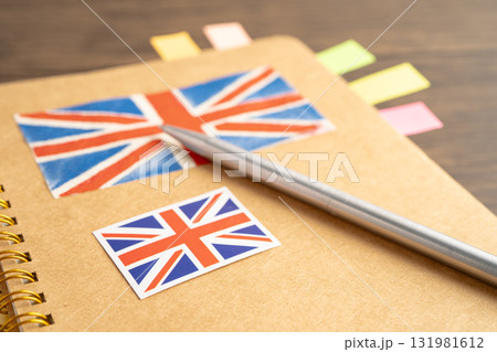 UK flag with pen on english language book. UK flag with pen on english language book. 131981612
