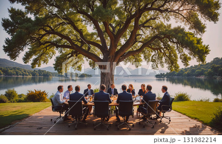 Group of people are gathered around a grill, cooking and eating food. The atmosphere is casual and social, with everyone enjoying the outdoor gathering 131982214