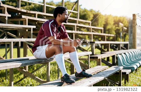 Rugby, sports or black man on pavilion thinking of training, exercise or workout game on grass field. Wellness, focus or African athlete with a vision, motivation or fitness goals sitting on a bench 131982322