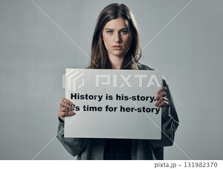 Protest, feminism and portrait of woman activist, poster in studio and mission isolated on grey background. Mockup, feminist and protesting in support of human rights, freedom and equality for women. Protest, feminism and portrait of woman activist, poster in studio and mission isolated on grey background. Mockup, feminist and protesting in support of human rights, freedom and equality for women. 131982370