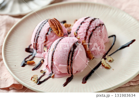pink raspberry ice cream decorated with chocolate sauce on plate pink raspberry ice cream decorated with chocolate sauce on plate 131983634