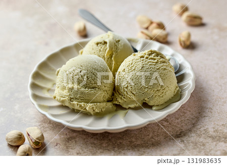 pistachio ice cream scoops on beige plate pistachio ice cream scoops on beige plate 131983635