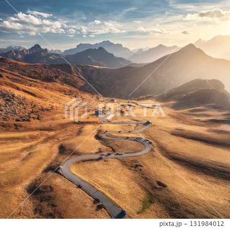 Aerial view of road in mountain valley at sunset in autumn 131984012