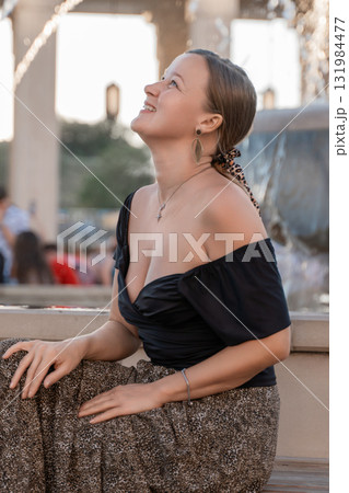 Woman Smiling Fountain Cityscape - Portrait of a young woman smiling at a fountain in a city. Woman Smiling Fountain Cityscape - Portrait of a young woman smiling at a fountain in a city. 131984477