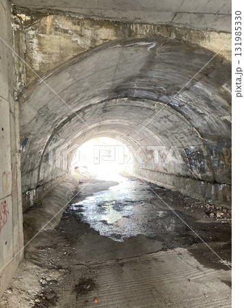 An old tunnel under the road at the other end you can see the sun 131985330