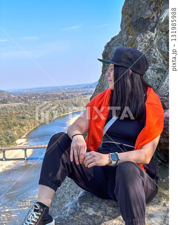 Person Enjoying Scenic View from Rocky Cliff 131985988