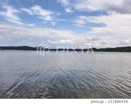 Enjoying a Tranquil Lake View Under Scenic and Picturesque Clouds Above the Landscape 131986439