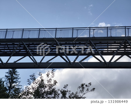 A Stylish Pedestrian Bridge Against a Clear Blue Sky, Creating an Appealing View 131986449