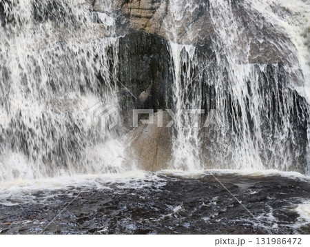 A Majestic Waterfall Cascading Beautifully Over Stunning Rock Formation in Nature A Majestic Waterfall Cascading Beautifully Over Stunning Rock Formation in Nature 131986472
