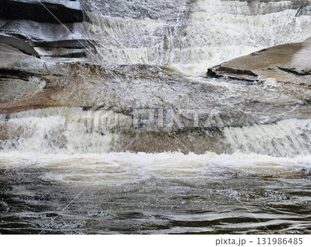 A Serene Waterfall Gracefully Cascading Down Majestic Rock Formations, Creating Beauty 131986485