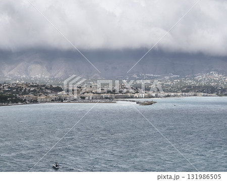 Stunning Coastal Landscape Featuring Dramatic Clouds and Serene, Calm Waters for Relaxation 131986505