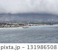 Enjoy this stunning scenic coastal view featuring majestic mountains under a cloudy sky 131986508