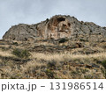 A Majestic Rocky Outcrop Rising High and Proud Beneath a Dramatic and Cloudy Sky Above 131986514