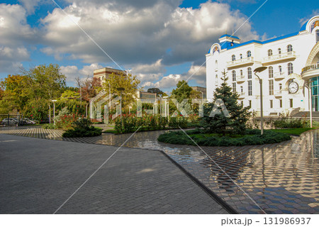 The building of the international academic school in Odessa. A richly decorated neoclassical building with beautiful flowerbeds and marble tiles in front of the building. The building of the international academic school in Odessa. A richly decorated neoclassical building with beautiful flowerbeds and marble tiles in front of the building. 131986937